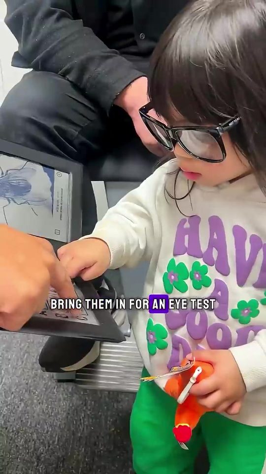 A toddler in glasses playing in the clinic
